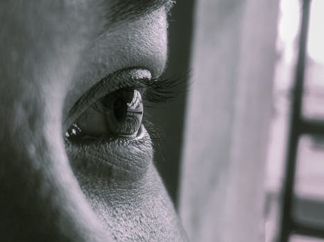 Detailed close-up of a human eye showcasing eyelashes and skin texture.