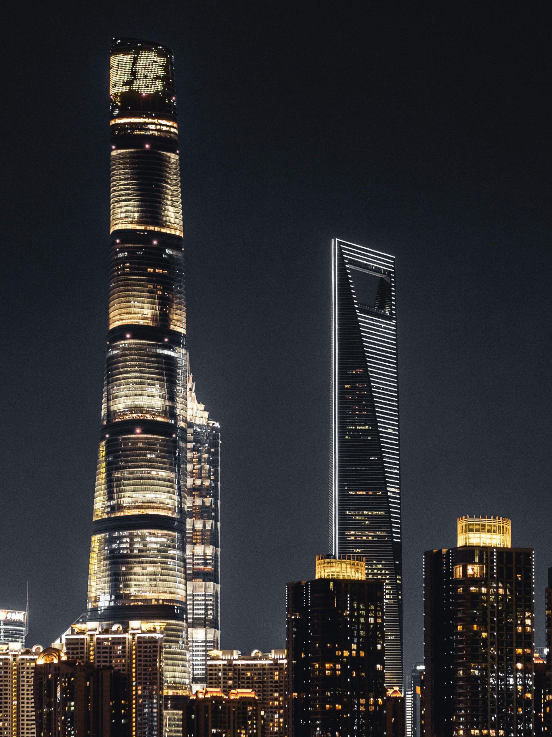 Shanghai skyline illuminated against the night sky featuring iconic skyscrapers.